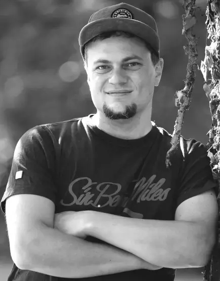 Andreas Wasicki - Smiling film crew member outdoors – Videoproduktion München.