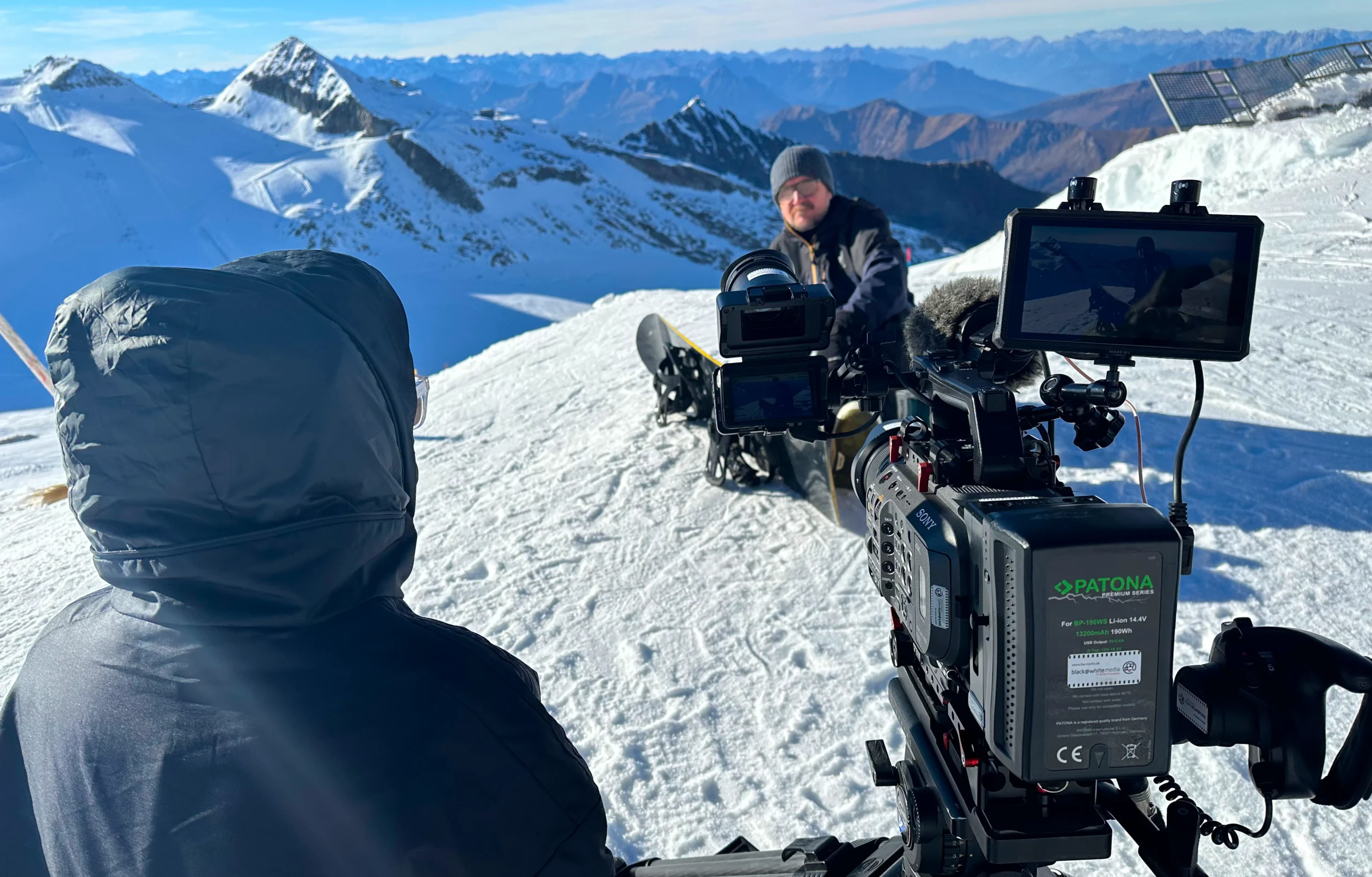 ENG Team and Kameramann filming on snowy mountains near München during professional videoproduktion project.